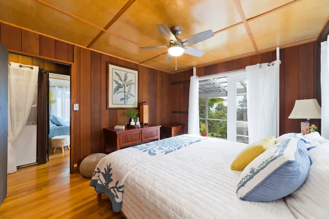 a bedroom with a bed mirror and a window