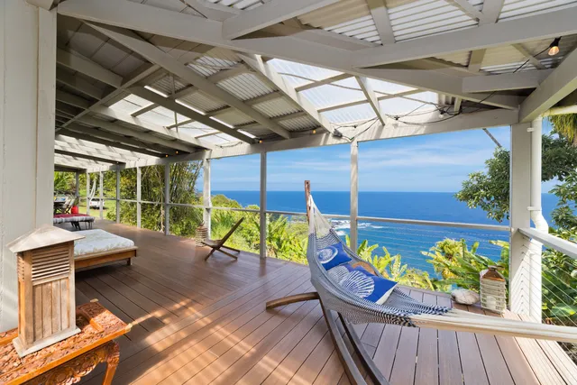a view of a chairs and table in the balcony