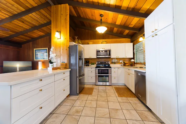 a kitchen with cabinets and white appliances
