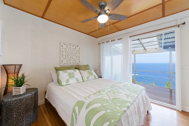 a bedroom with a bed dresser and a window