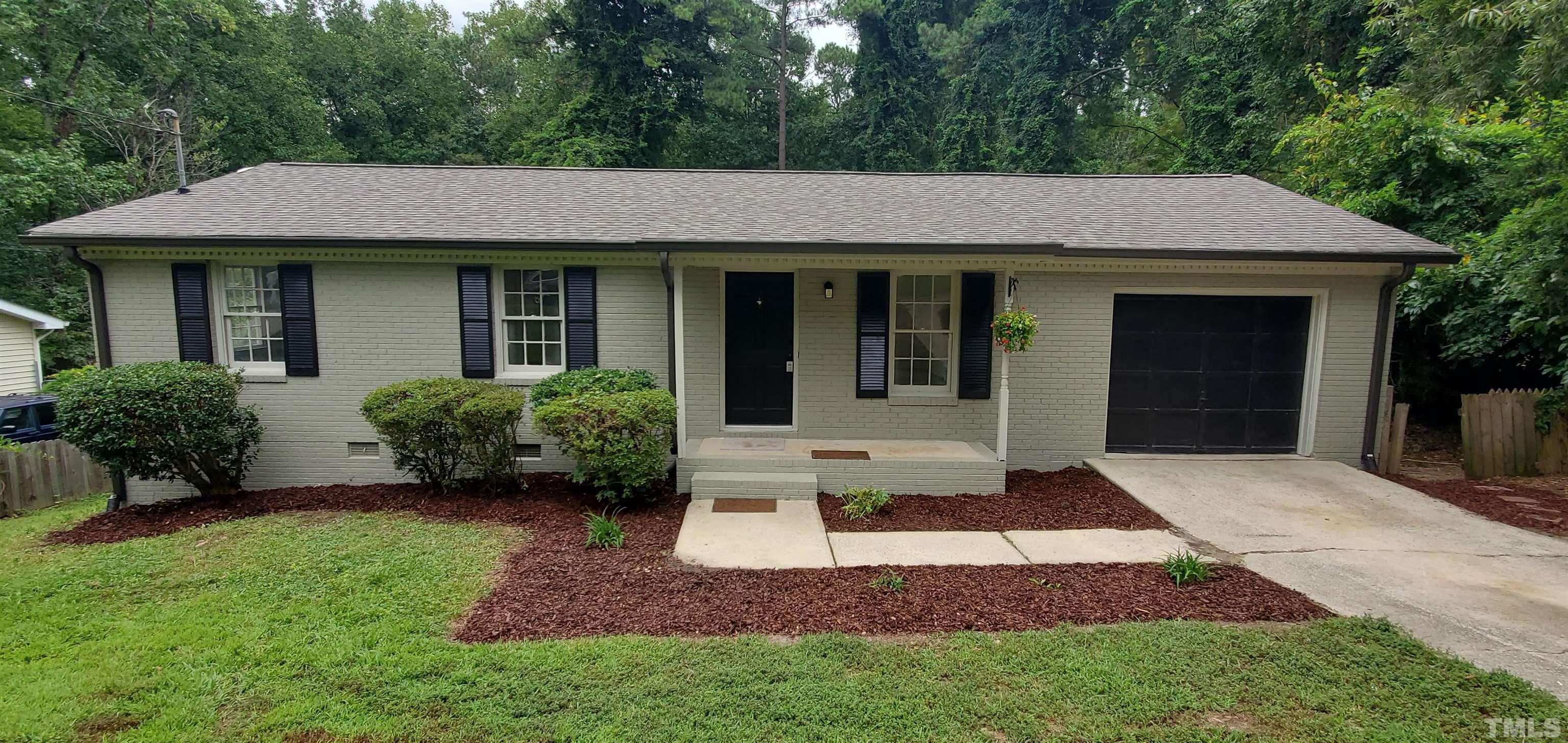 3817 Corwin Road Garner, NC 27529 - Photo 1 of 21 a view of a white house with a small yard plants and a large tree