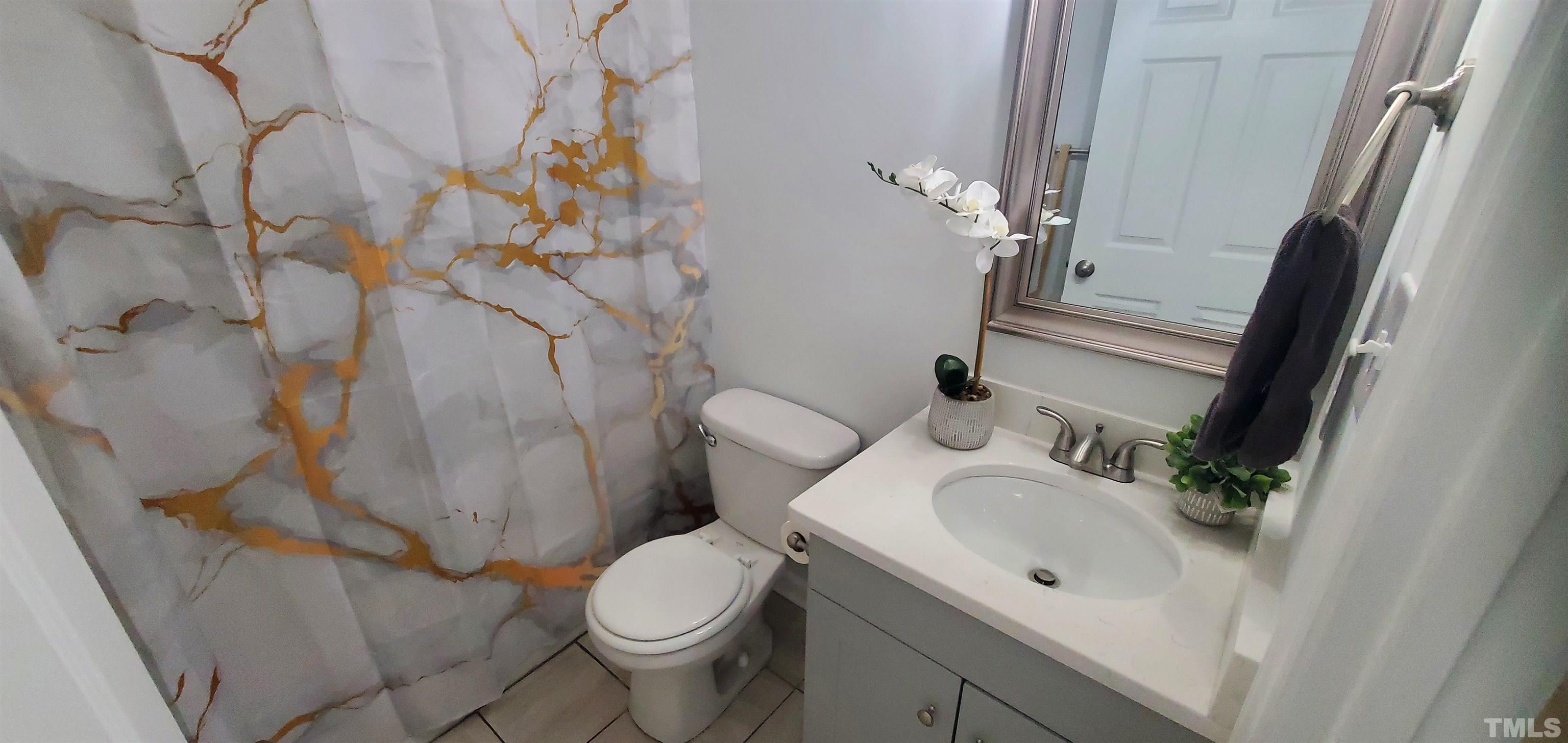 3817 Corwin Road Garner, NC 27529 - Photo 13 of 21 a white toilet sitting next to a bathroom sink