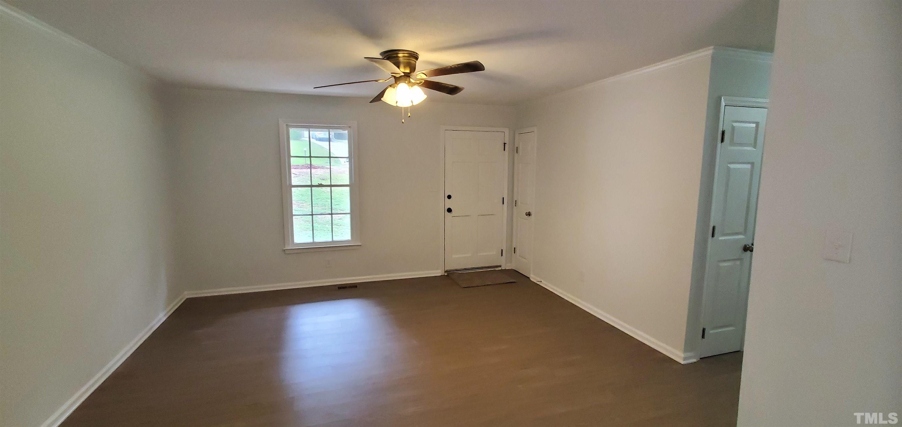 3817 Corwin Road Garner, NC 27529 - Photo 2 of 21 an empty room with windows and fan