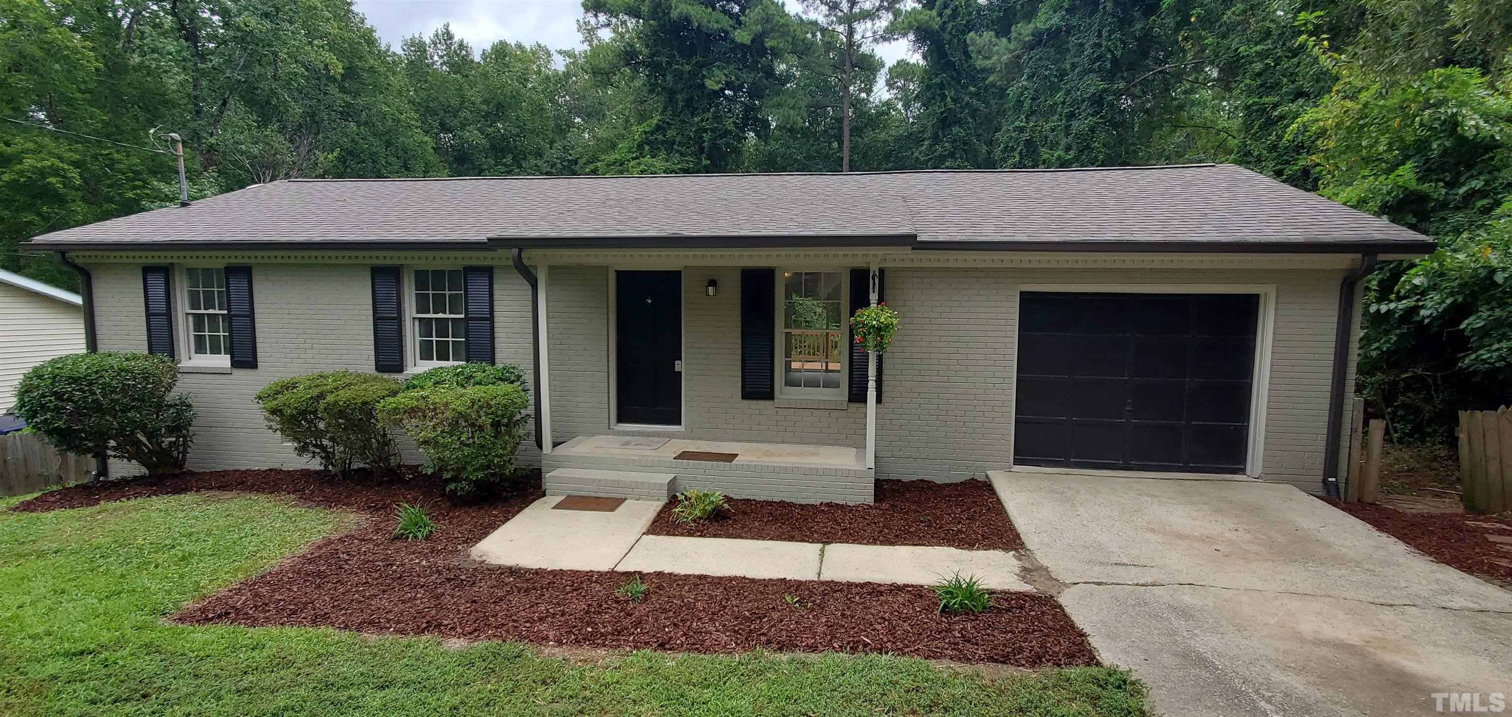 3817 Corwin Road Garner, NC 27529 - Photo 21 of 21 a view of a white house with a small yard plants and large tree