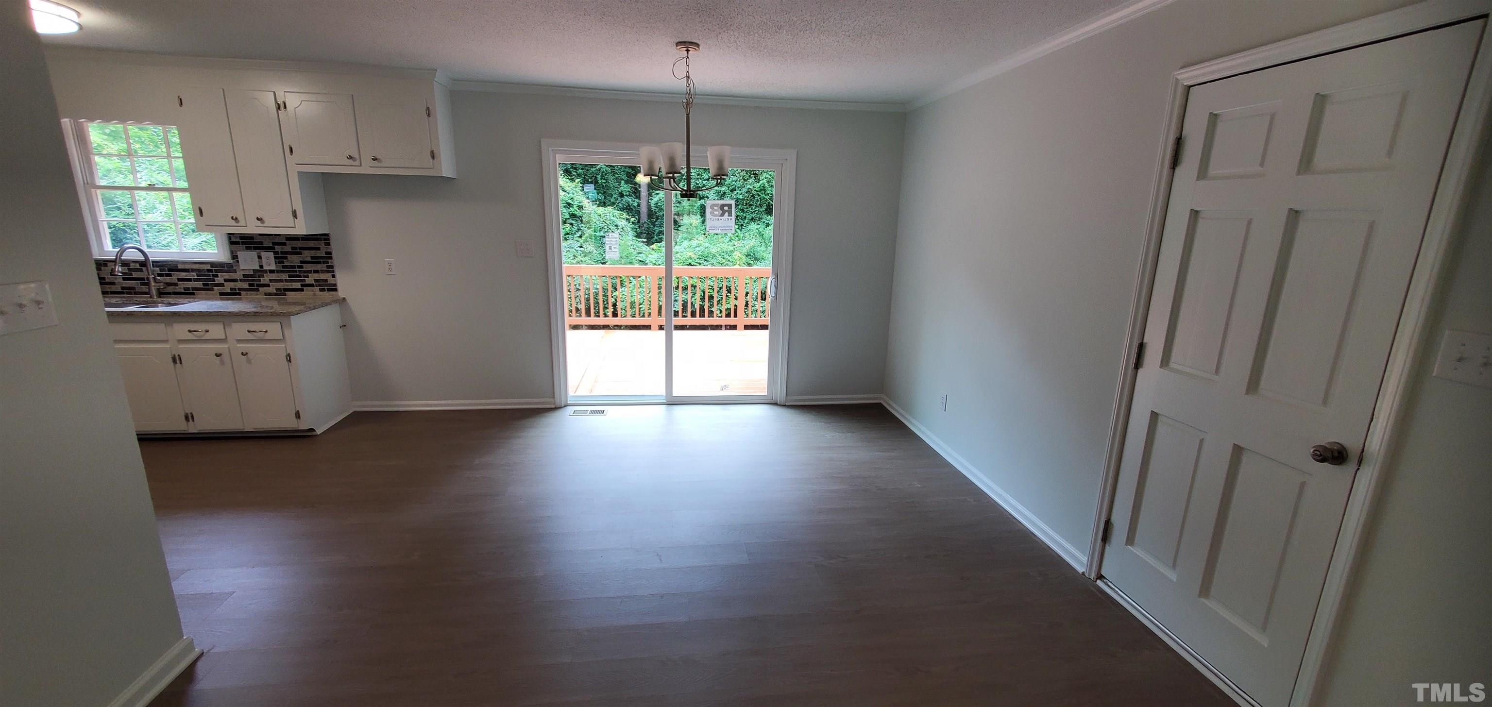 3817 Corwin Road Garner, NC 27529 - Photo 4 of 21 a kitchen with granite countertop stainless steel appliances a counter space and wooden floor