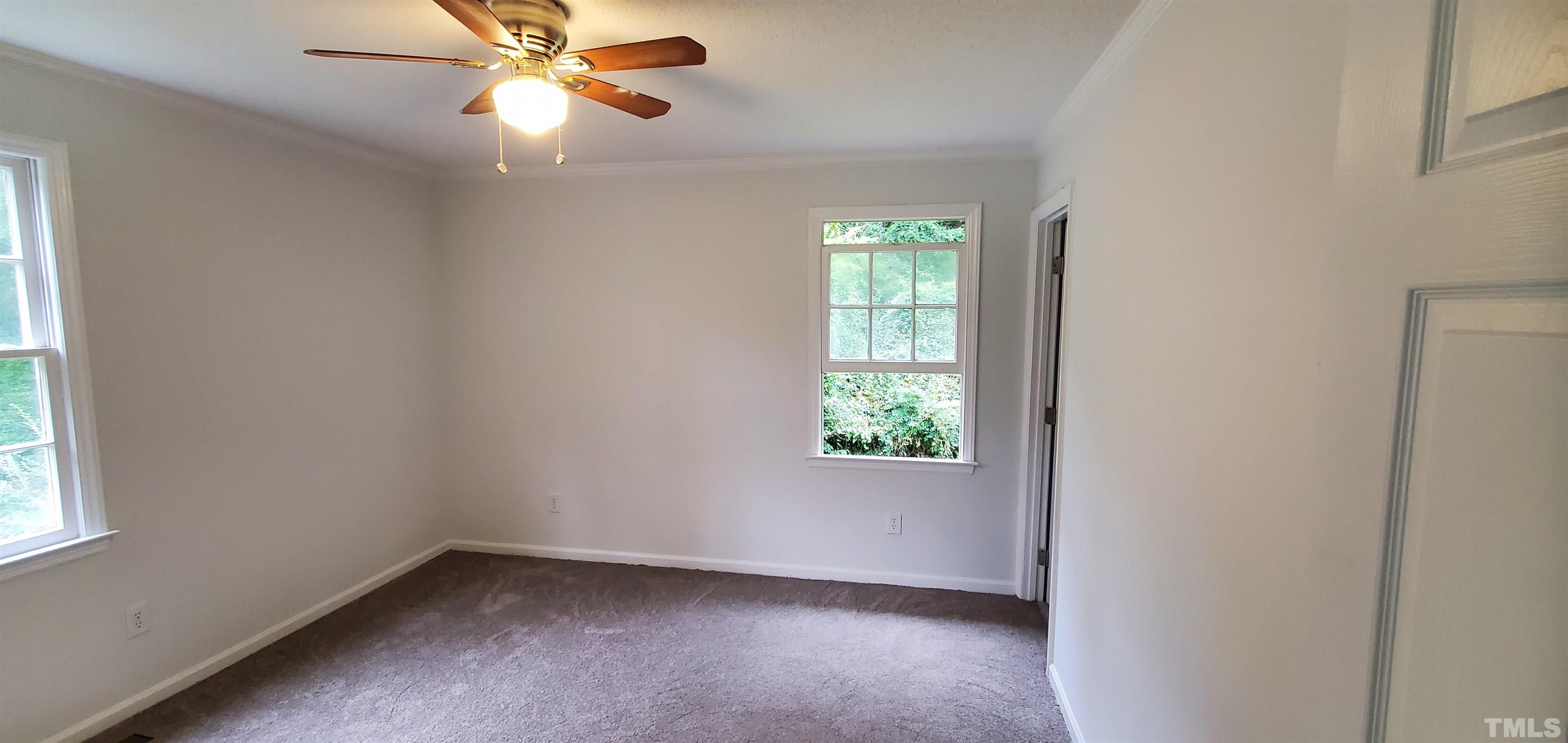 3817 Corwin Road Garner, NC 27529 - Photo 8 of 21 an empty room with windows and fan