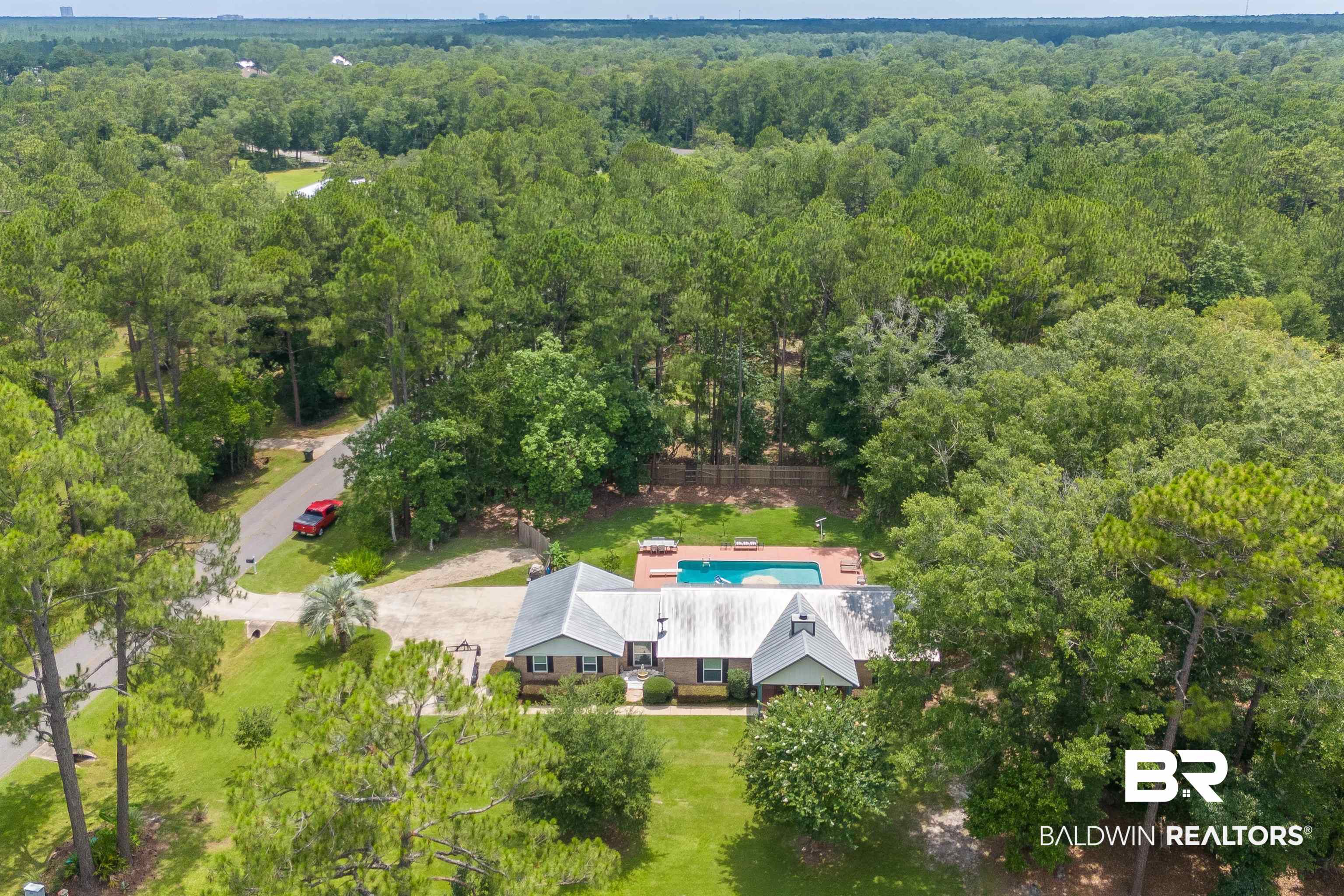 24551 Wolf Bay Drive Foley, AL 36535 - Photo 50 of 59 Drone / aerial view of a heavily wooded area and a pool
