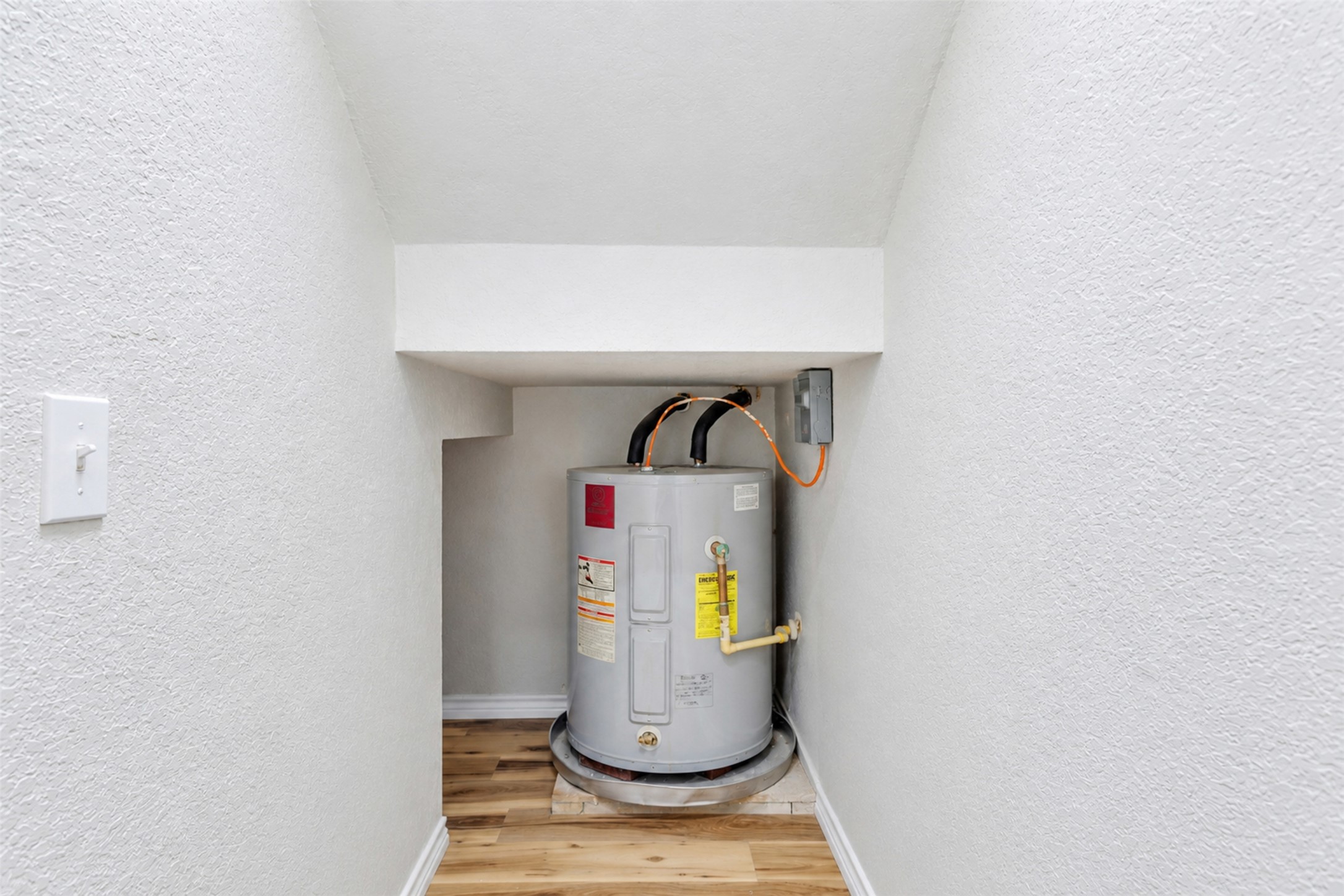 4523 Secure Lane Austin, TX 78725 - Photo 11 of 40 Essential water heater neatly tucked away in a functional utility closet.