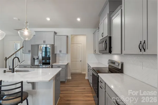 a kitchen with a sink stove and refrigerator