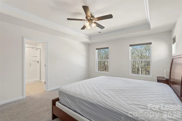 a bedroom with a bed and a ceiling fan