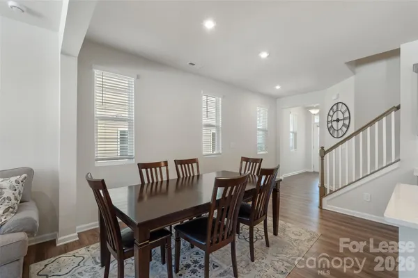 a view of a a dining room with furniture window and wooden floor