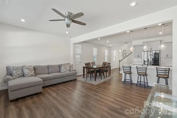 a living room with furniture and kitchen view