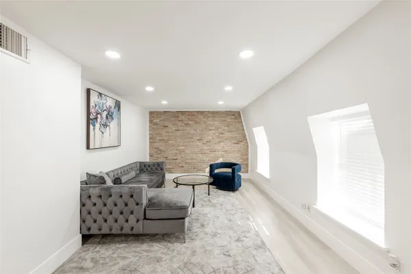 a living room with furniture two couch and a window