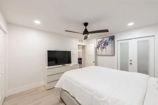 a bedroom with a bed and a flat screen tv