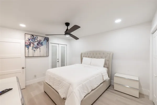 a bedroom with a bed and a painting on the wall