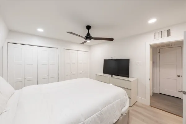 a bedroom with a bed and a flat screen tv