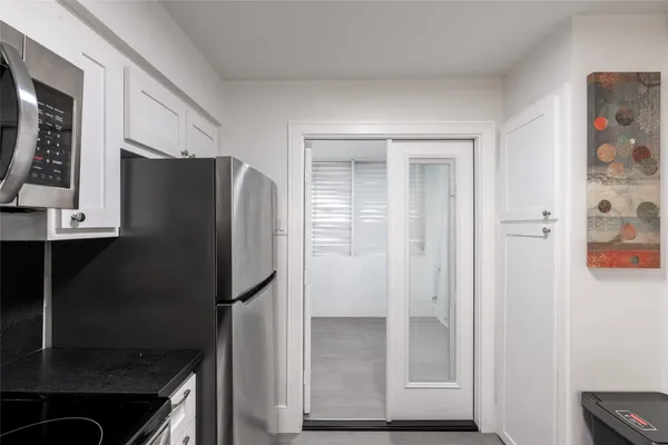 a kitchen with a refrigerator and a stove