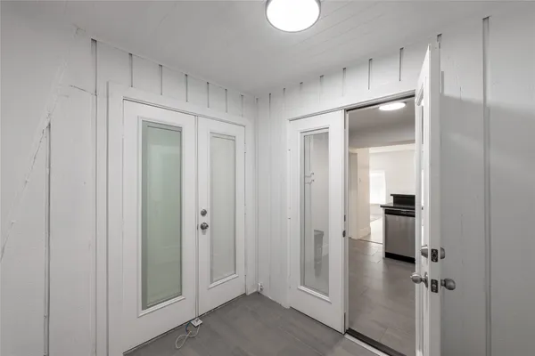a view of a room with an entryway door