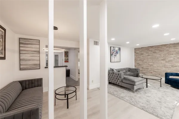 a living room with furniture and a hard wood floor