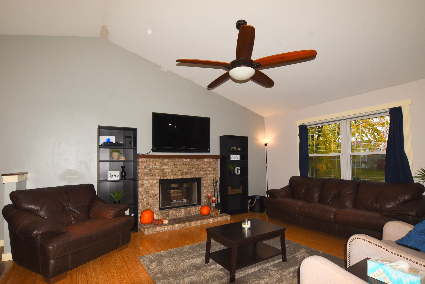 1011 Cardinal Drive Zion, IL 60099 - Photo 3 of 23 a living room with furniture a fireplace and a flat screen tv