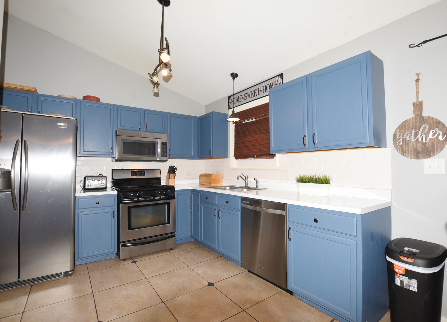 1011 Cardinal Drive Zion, IL 60099 - Photo 5 of 23 a kitchen with a sink stainless steel appliances and cabinets