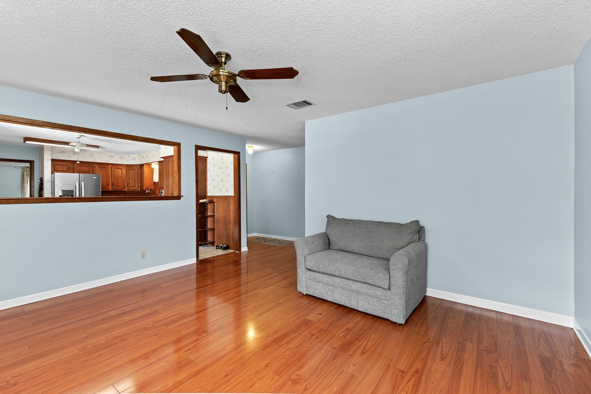 5600 Libyan Circle Austin, TX 78745 - Photo 8 of 37 Unfurnished room with a textured ceiling, ceiling fan, and light wood finished floors