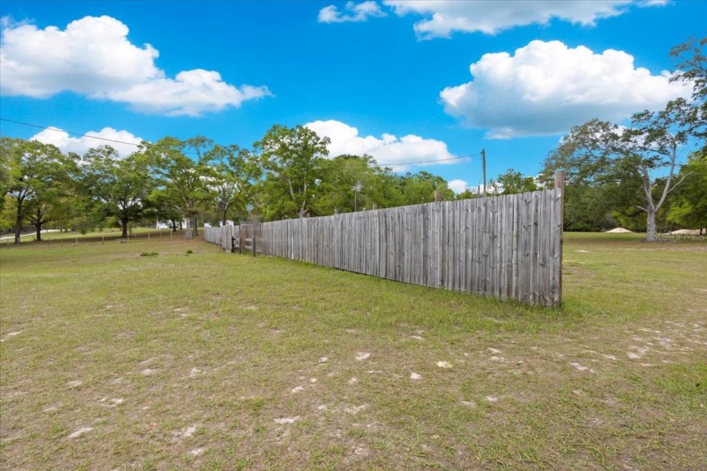 3100 Northwest 20th Street Bell, FL 32619 - Photo 12 of 39 a view of a yard with an tree and wooden fence