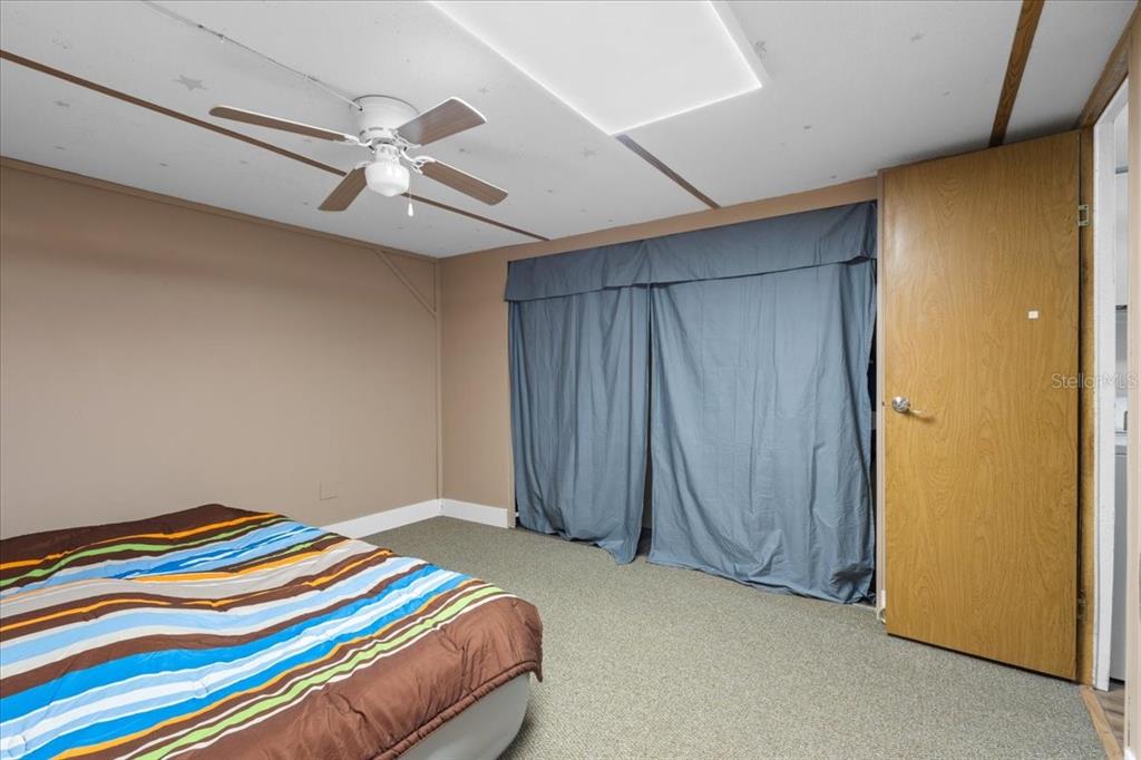 3100 Northwest 20th Street Bell, FL 32619 - Photo 15 of 39 a bedroom with a bed and a chandelier