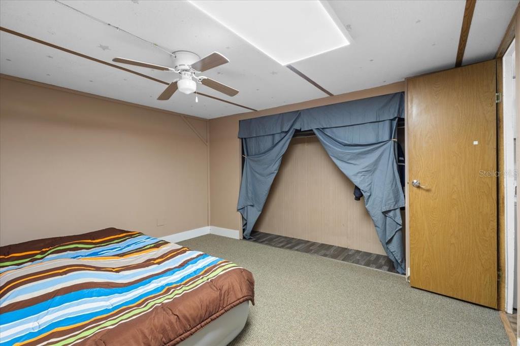 3100 Northwest 20th Street Bell, FL 32619 - Photo 16 of 39 a bedroom with a bed and a ceiling fan