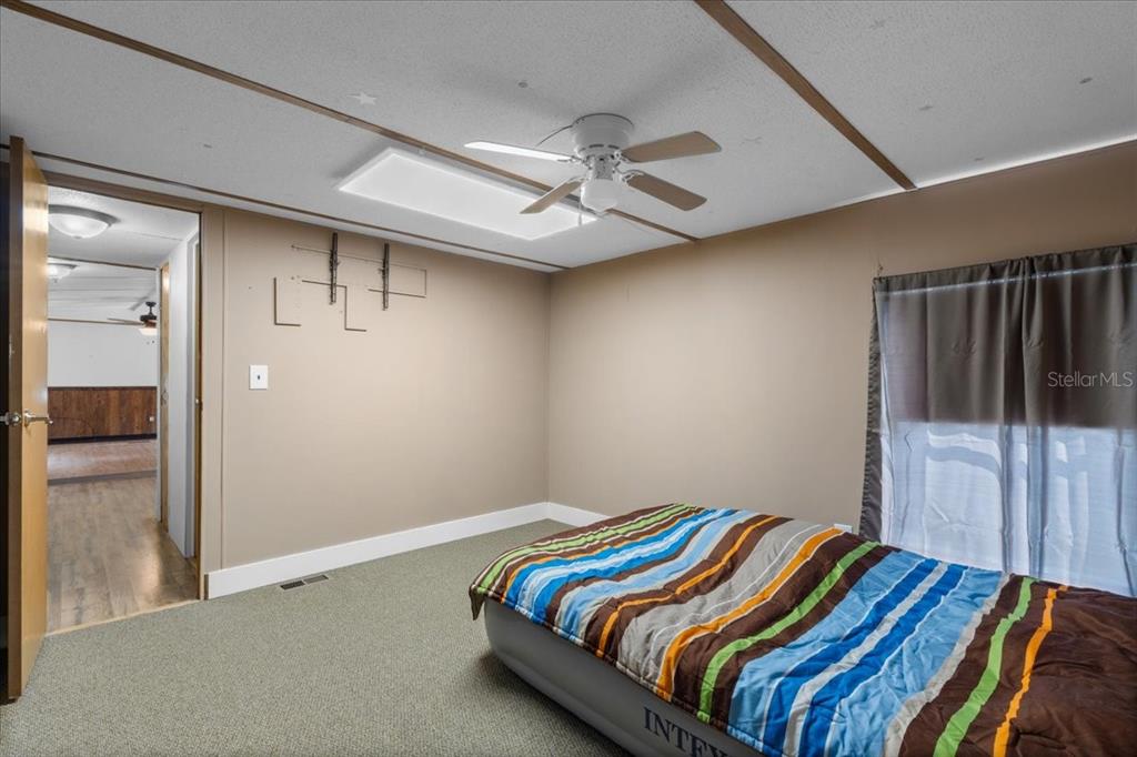 3100 Northwest 20th Street Bell, FL 32619 - Photo 17 of 39 a bedroom with a bed and a ceiling fan
