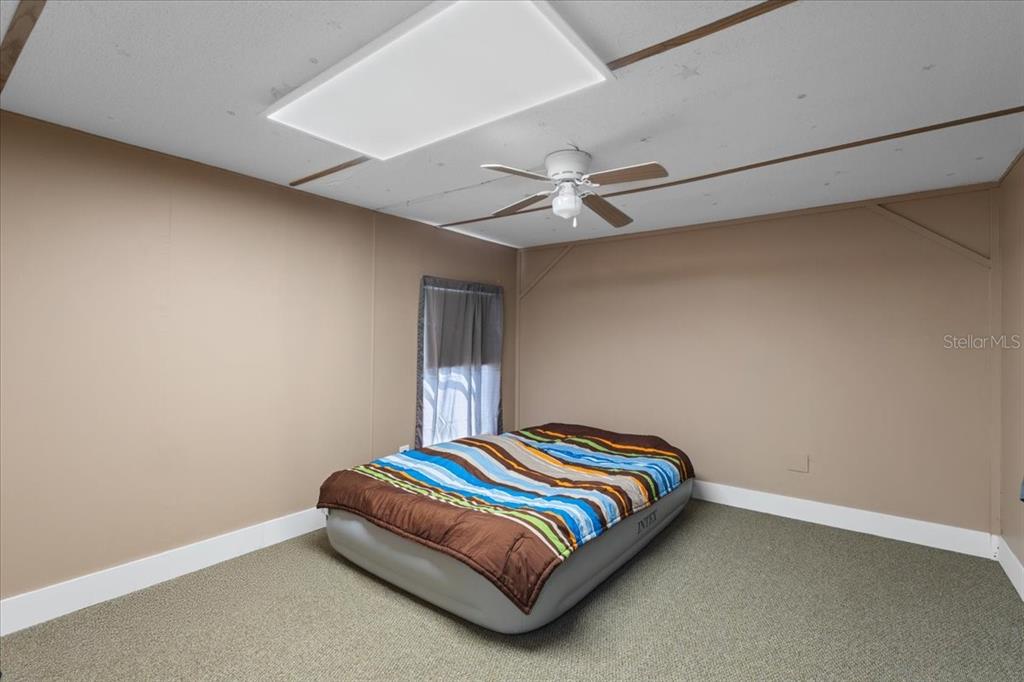 3100 Northwest 20th Street Bell, FL 32619 - Photo 18 of 39 a bedroom with a bed and fan