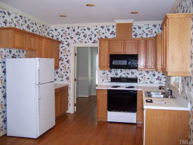 7229 Mine Shaft Road Raleigh, NC 27615 - Photo 3 of 6 a kitchen with stainless steel appliances a stove a refrigerator and a oven