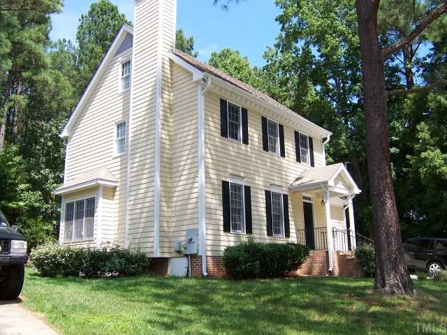 7229 Mine Shaft Road Raleigh, NC 27615 - Photo 5 of 6 a front view of a house with a yard and trees