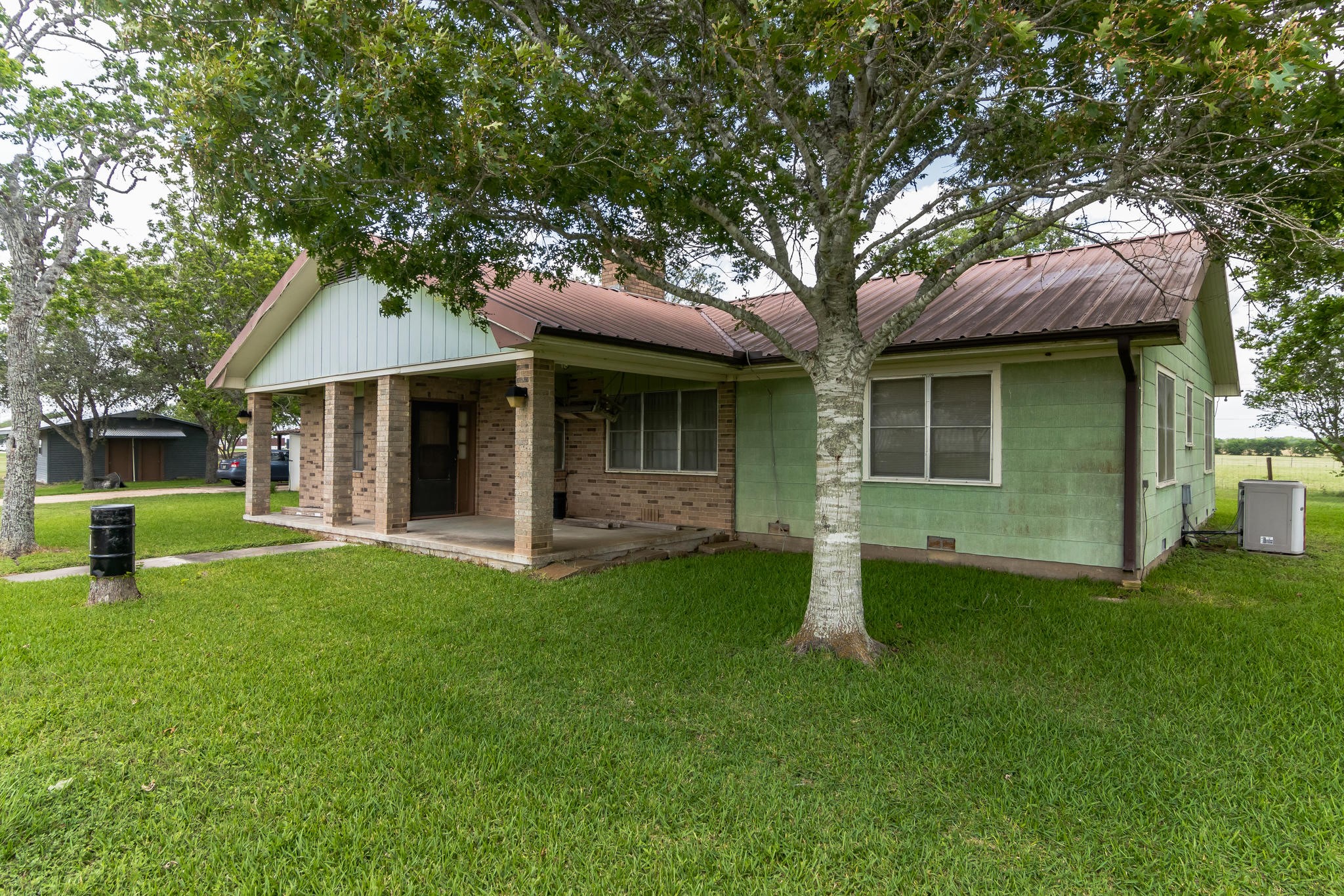 1230 FM 155 Weimar, TX 78962 - Photo 19 of 27 a front view of a house with a garden and yard
