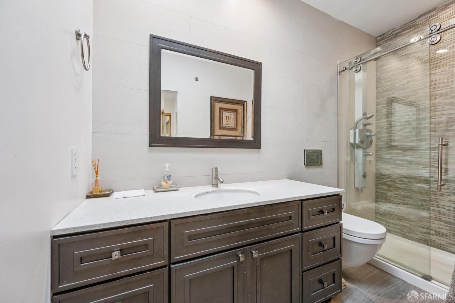 335 South Van Ness Avenue San Francisco, CA 94103 - Photo 5 of 17 a bathroom with a sink a toilet and shower