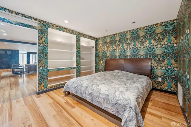 a bedroom with a bed and a view of balcony