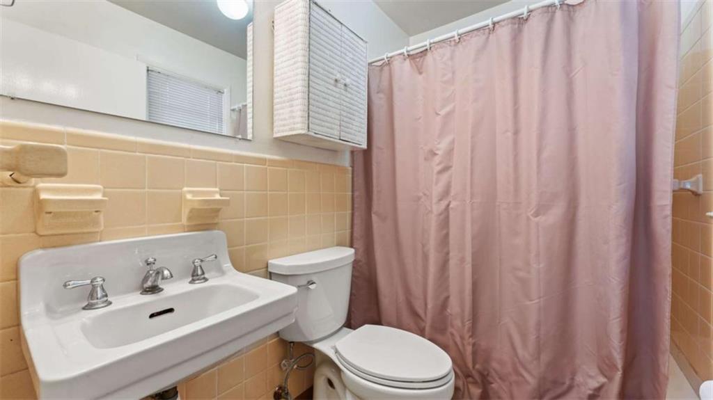 8 Lakemoore Drive Northeast Rome, GA 30161 - Photo 14 of 44 a bathroom with a sink a toilet and shower curtain