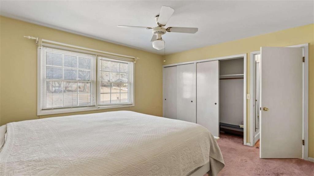 8 Lakemoore Drive Northeast Rome, GA 30161 - Photo 18 of 44 a bedroom with a large bed and a chandelier