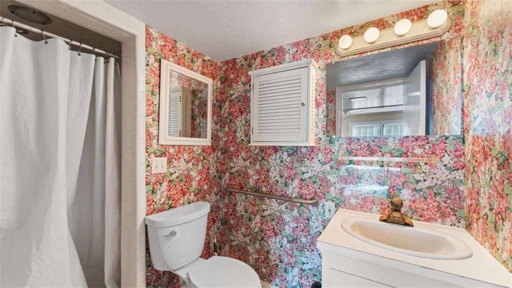 8 Lakemoore Drive Northeast Rome, GA 30161 - Photo 28 of 44 a bathroom with a sink a toilet and shower curtain