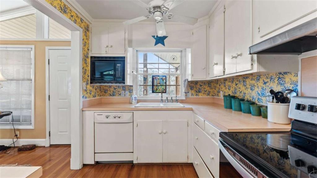 8 Lakemoore Drive Northeast Rome, GA 30161 - Photo 10 of 44 a kitchen with a sink stove and cabinets