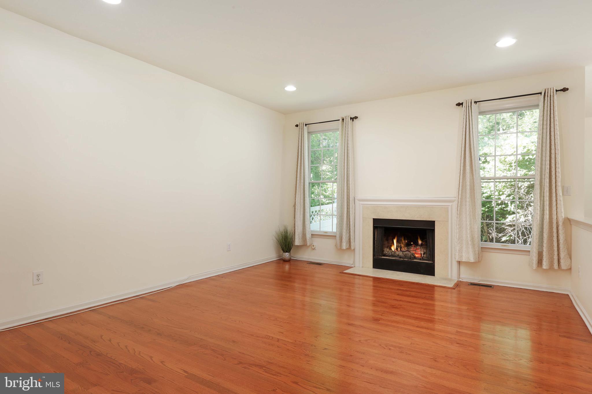 11 Wedgewood Court Princeton, NJ 08540 - Photo 11 of 40 a view of an empty room with wooden floor fireplace and a window