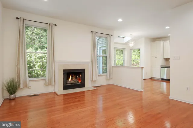 a view of an empty room with a window and fireplace