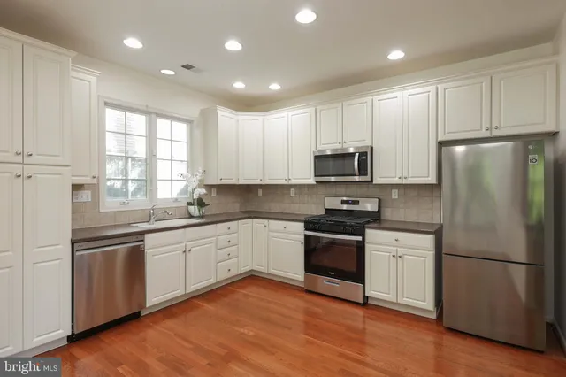 a kitchen with granite countertop stainless steel appliances and wooden cabinets