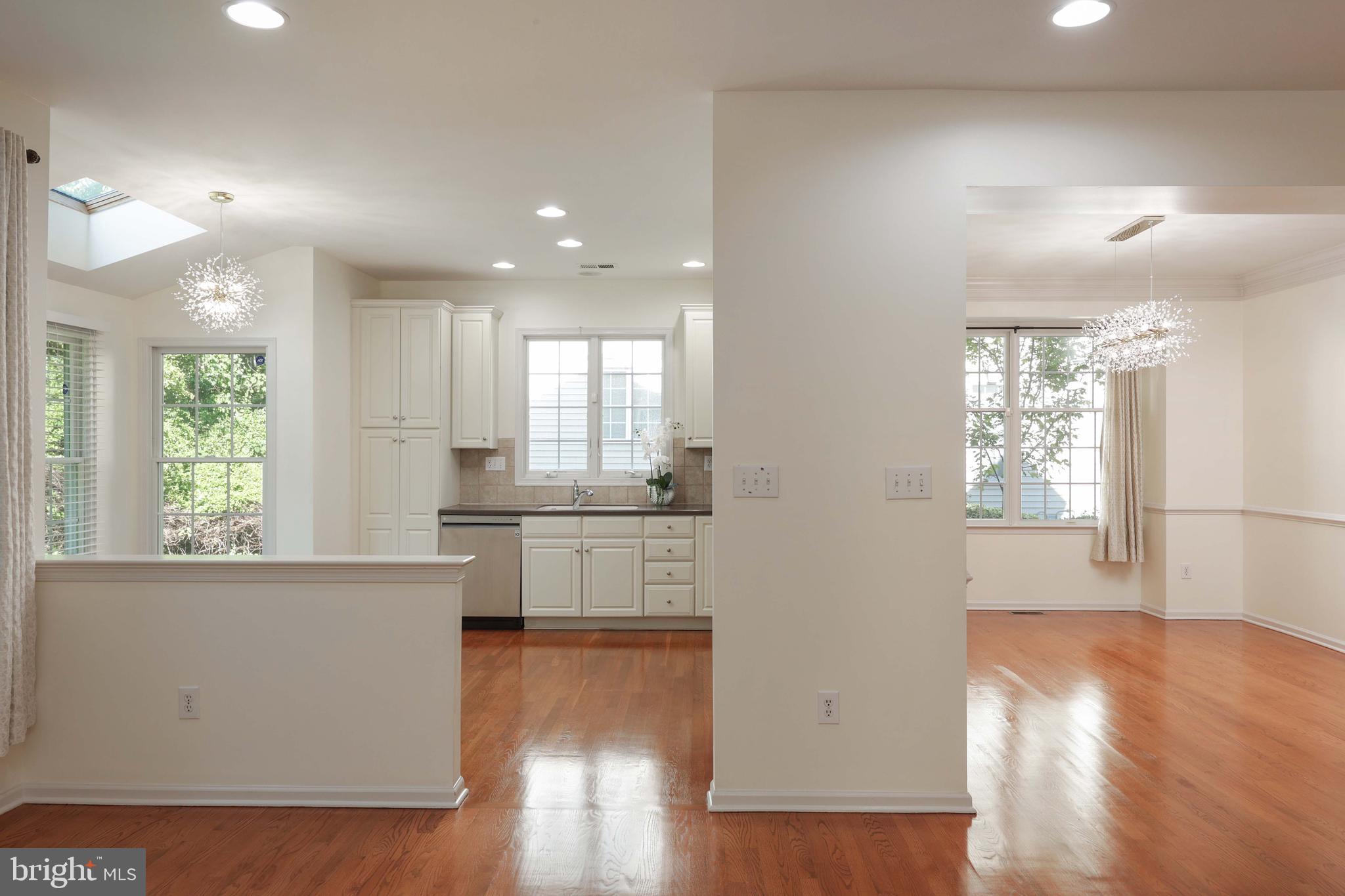 11 Wedgewood Court Princeton, NJ 08540 - Photo 15 of 40 a kitchen with stainless steel appliances granite countertop a refrigerator a sink dishwasher a stove white countertops and wooden floor