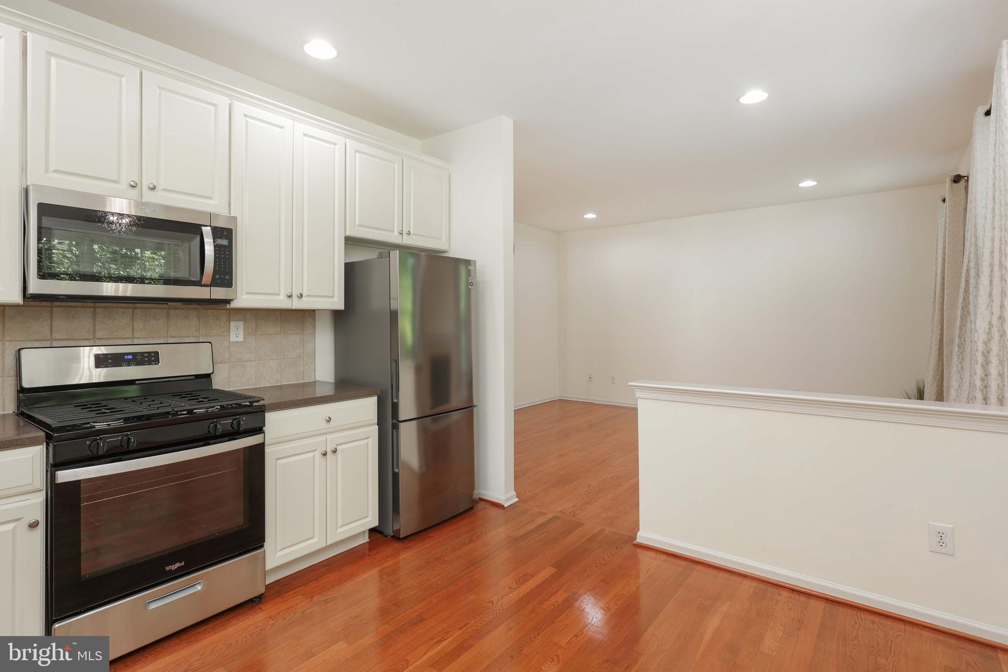 11 Wedgewood Court Princeton, NJ 08540 - Photo 18 of 40 a kitchen with granite countertop a refrigerator stove and microwave