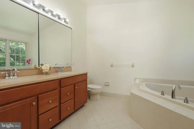 a white bath tub sitting next to a shower