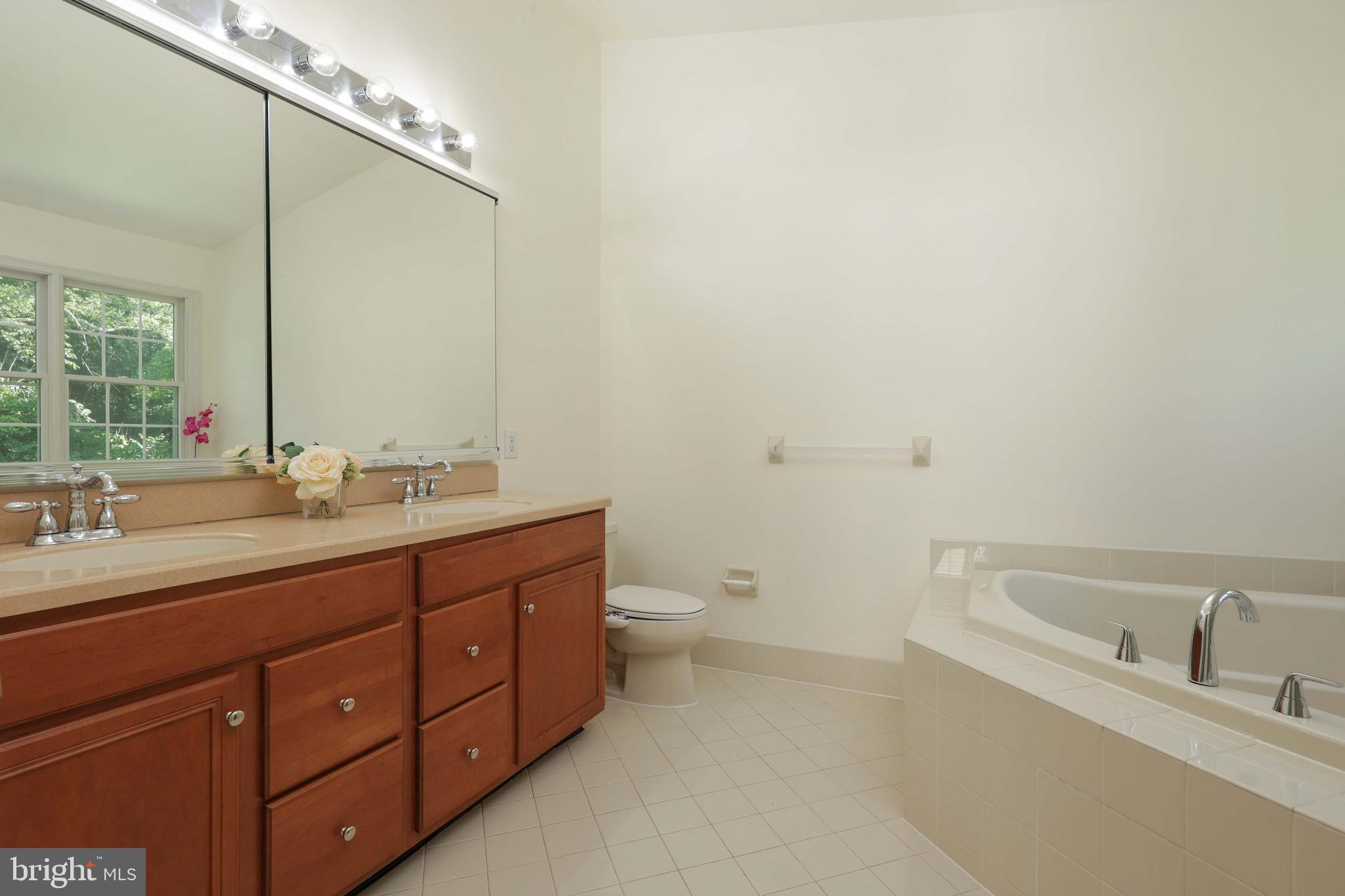 11 Wedgewood Court Princeton, NJ 08540 - Photo 22 of 40 a bathroom with a granite countertop sink a toilet and a bathtub