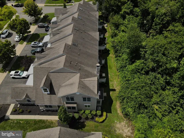 an aerial view of a house with a yard and lake view