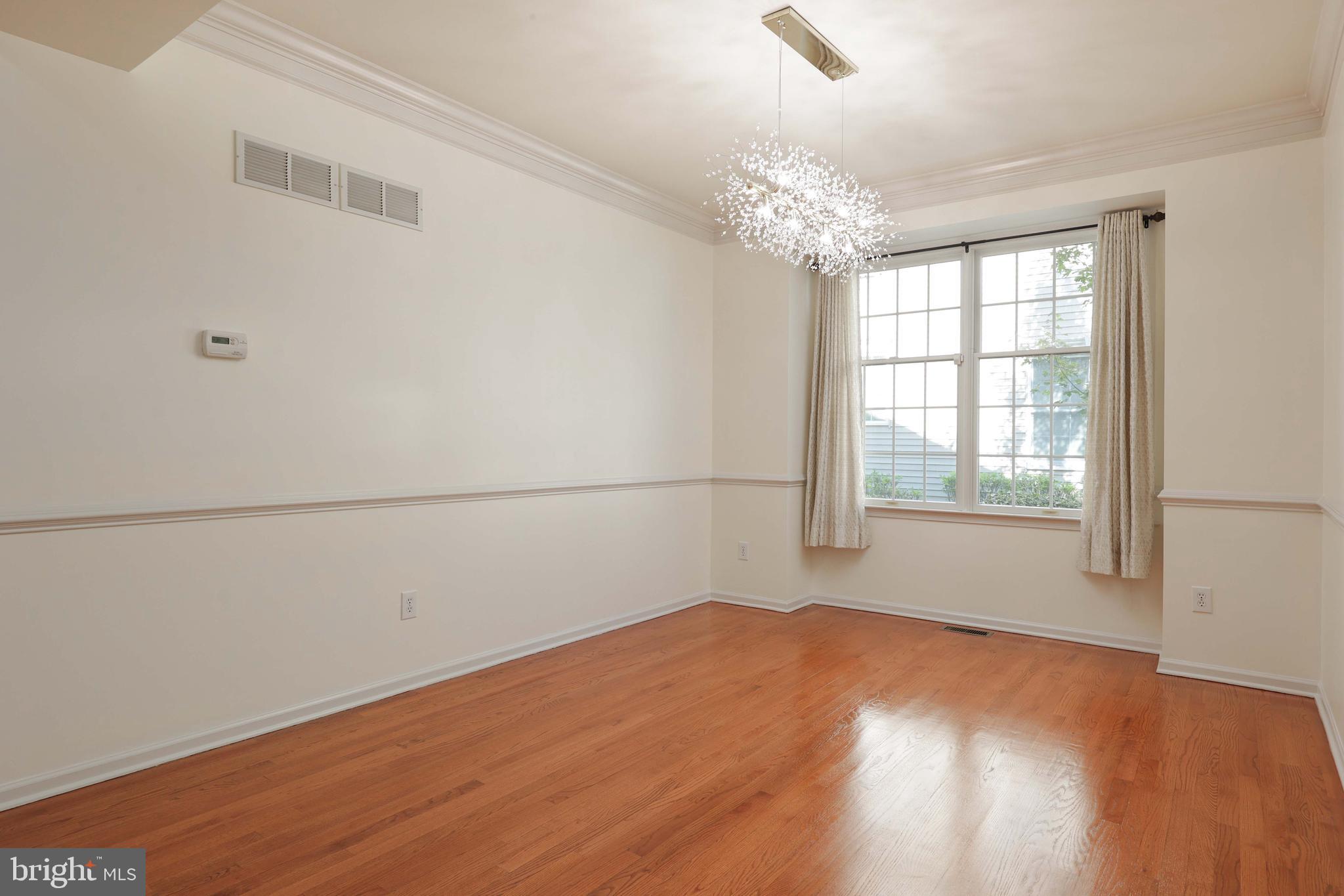 11 Wedgewood Court Princeton, NJ 08540 - Photo 9 of 40 an empty room with wooden floor and windows