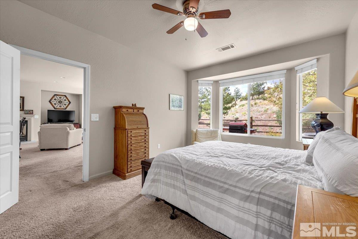 1205 Firefly Court Reno, NV 89523 - Photo 23 of 39 a bedroom with a bed and wooden floor